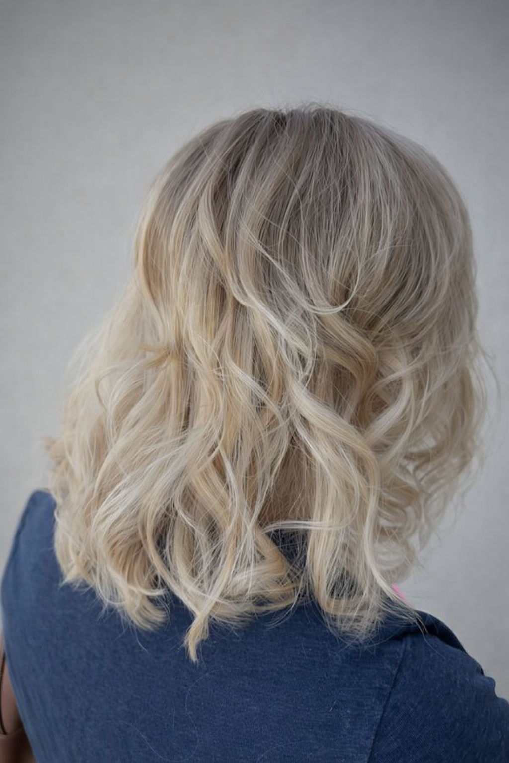 Soft ash blonde with shadow root. Effortless, lived-in color with full movement.