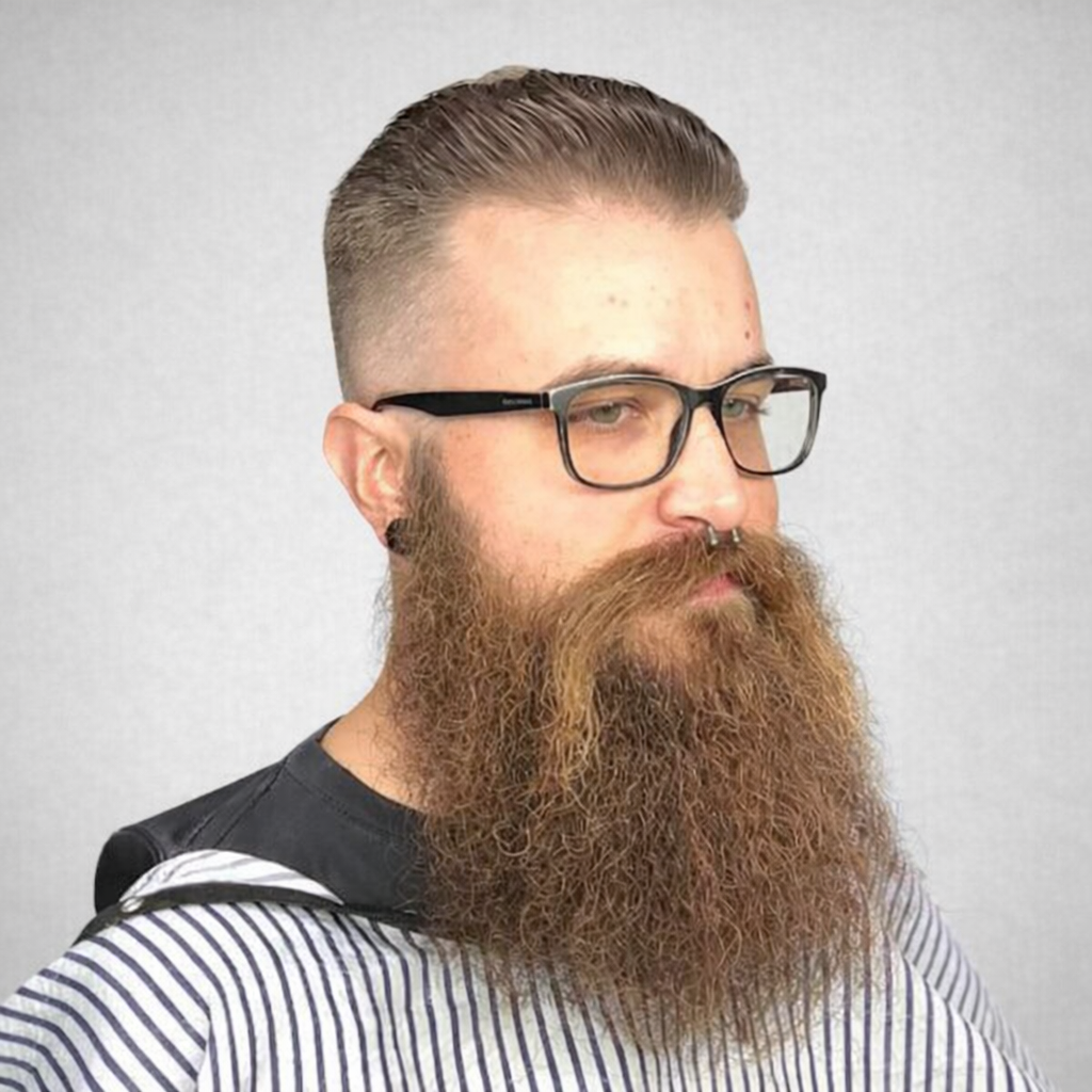 Clean taper fade with slicked-back length on top. Sharp lines, strong finish.